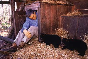 Houdini, Yoda, and Kilham in a straw-filled den - Photo by Robert Caputo