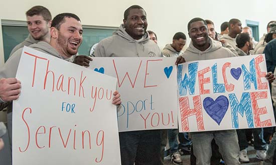 UNH football players welcome home soldiers