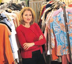Ellen Kunes standing amongst clothing