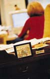 Picture of boys on desk with Ellen Kunes in background